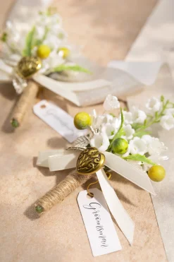 Boutonnieres in May Lily & Olive